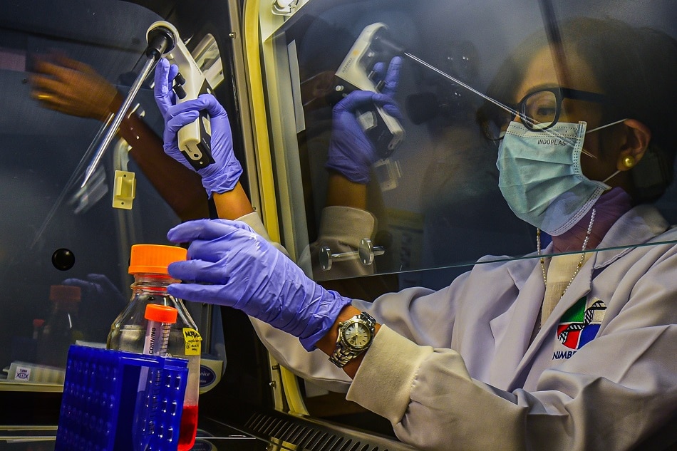 Dr. Pia Bagamasbad conducts a lab work at the National Institute of Molecular Biology Building at the University of the Philippines in Diliman, Quezon City in this photo taken on March 8, 2023. Maria Tan, ABS-CBN News