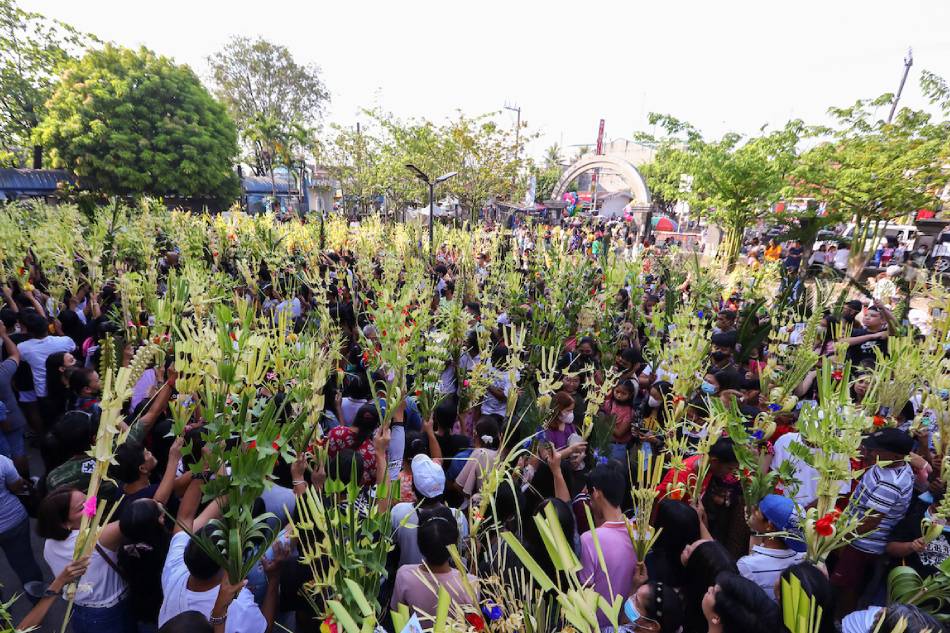 Catholic devotees wave their palm fronds during the Palm Sunday rites at the Nuestra Senora de Asuncion in Bulacan on April 2, 2023. Maria Tan, ABS-CBN News
