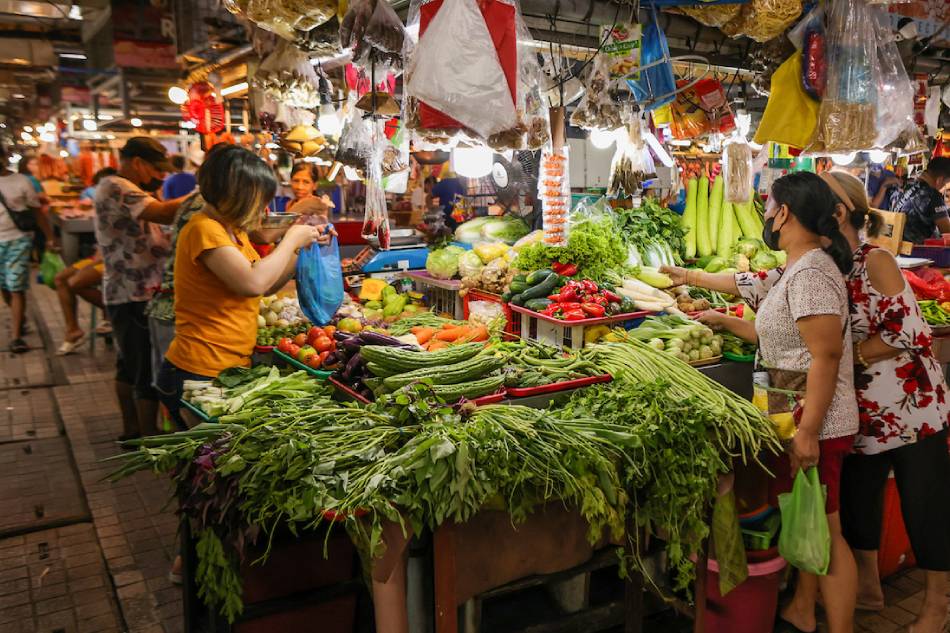 People buy various meat and produce at the Agora Public Market in San Juan City on February 21, 2023. The local government along with officials of the MMDA and DTI inspected the market on the same day to ensure vendors are complying with the suggested retail price set by authorities for commodities to protect consumers. Maria Tan, ABS-CBN News