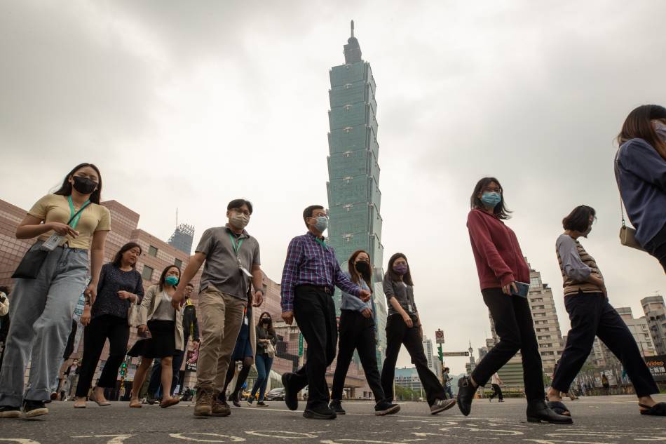 People walk near Taipei 101 skyscraper building, in Taipei, Taiwan, April 6, 2023. The meeting between US House Speaker Keven McCarthy and Taiwan President Tsai Ing-wen on April 5 in the United States was deemed 'crossing the red line' by the China Foreign Affairs Committee of the National People's Congress. Ritchie B. Tongo, EPA-EFE
