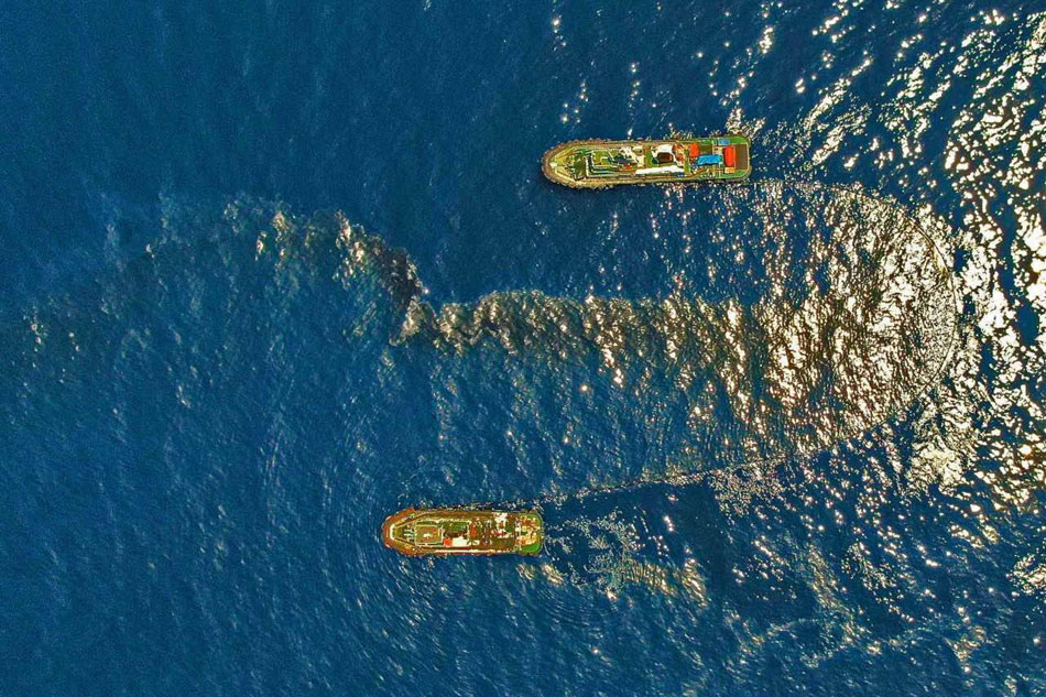 The Philippine Coast Guard deploy an oil spill boom and skimmer with manual scooping around the suspected area of the sunken MT Princess Empress approximately 7.1 nautical miles northeast of the shorelines of Balingawan Port, Lucta Port, and Buloc Bay in Oriental Mindoro on March 14, 2023. Photo courtesy of Malayan Towage and Salvage Corporation/Philippine Coast Guard
