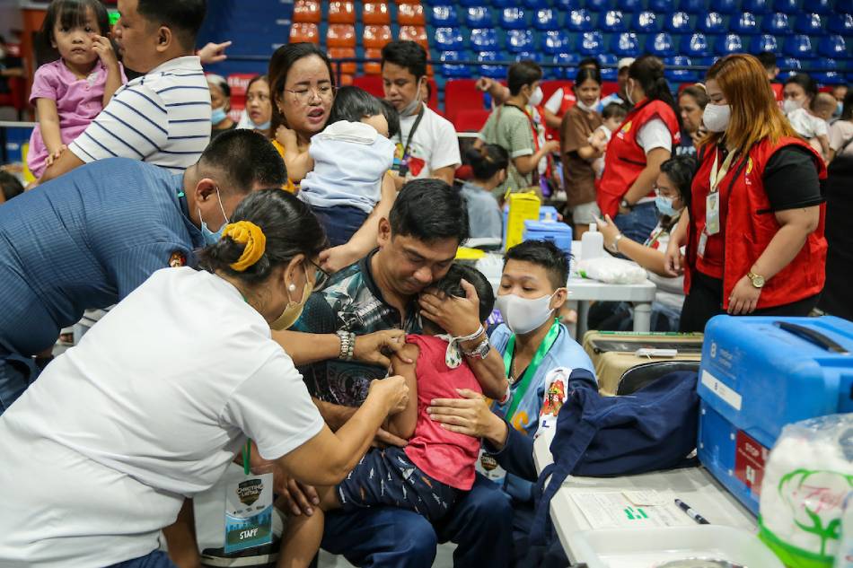 A child reacts as he gets vaccinated against childhood diseases as part of the Department of Health’s “Chikiting Ligtas” Vaccine Supplemental Immunization activity at FilOil Flying V Centre in San Juan City on April 27, 2023. Jonathan Cellona, ABS-CBN News