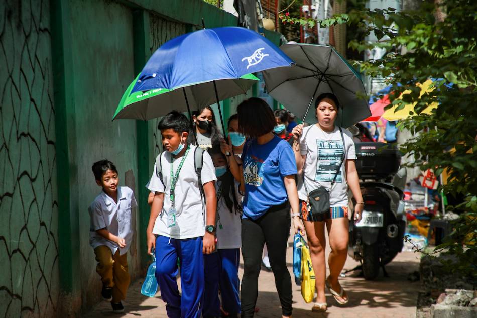 Guardians use sun protection against the hot weather as they fetch their children from a public school along Pedro Gil Street way in Manila on May 3, 2023. Jonathan Cellona, ABS-CBN News