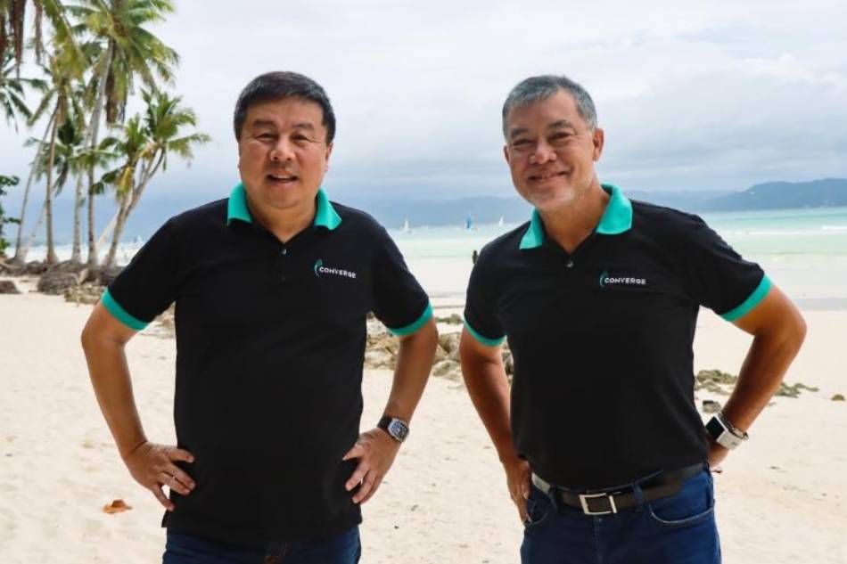 Converge CEO Dennis Anthony Uy and COO Jesus Romero in the popular white sand beach of Boracay. Handout