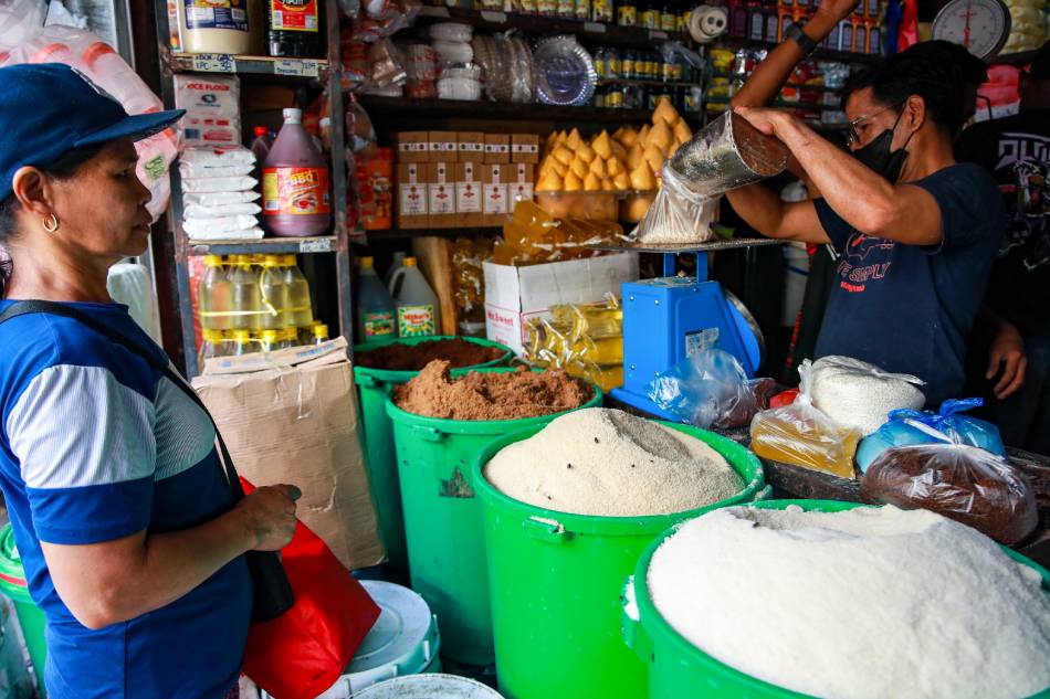  Store workers attend to customers buying sugar at their stall in Bagong Silang public market in North Caloocan on January 19, 2023. Jonathan Cellona, ABS-CBN News