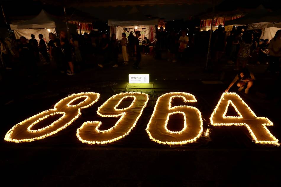 People place electric candles as they join a vigil during the commemoration of the 34th anniversary of the 1989 Tiananmen crackdown, in Taipei, Taiwan, 04 June 2023. In the early hours of 04 June 1989, Chinese troops cracked down on student protesters at Tiananmen Square in Beijing, leaving many students killed or injured. EPA-EFE/RITCHIE B. TONGO