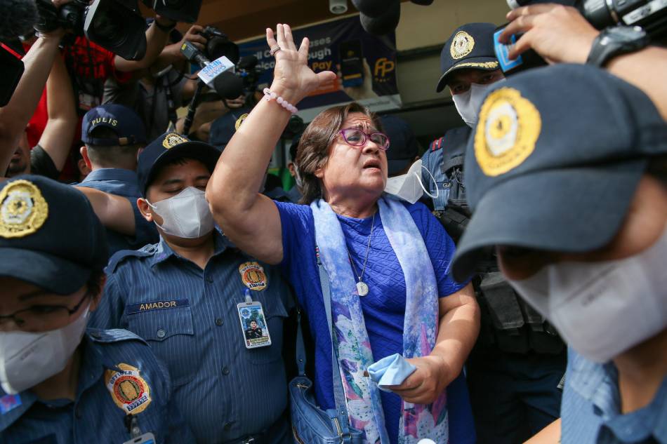 Senator Leila DeLima emerges from the Muntinlupa Regional Trial Court escorted by heavy security on May 12, 2023 after the court acquitted her of charges of illegal drug trading. Jonathan Cellona, ABS-CBN News/File.