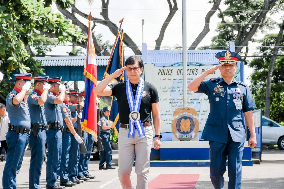 Interior Secretary Benjamin Abalos Jr. (left) and Central Visayas regional police director BGen. Anthony Aberin (right) salute as they arrive at the Negros Oriental Police Provincial Office headquarters in Agan-an, Sibulan town on July 8, 2023. Negros Oriental Police Provincial Office/Facebook