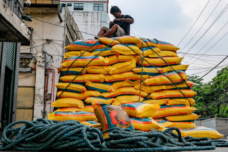 Workers unload sacks of rice from Thailand into a warehouse in Tondo, Manila on June 23, 2022. George Calvelo, ABS-CBN News