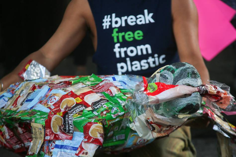 Environmental activists of Greenpeace hold placards and letters as they hold a ’Break Free From Plastics’ protest in front of the building where Nestle’ Philippines is located, in Makati City on March 23, 2022. Jonathan Cellona, ABS-CBN News