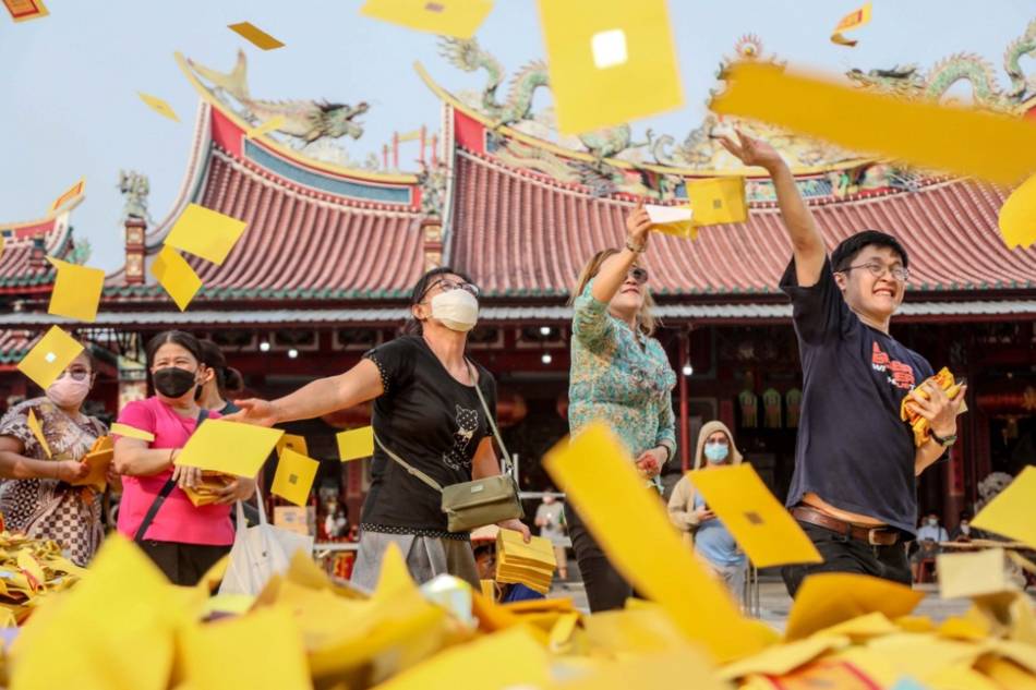 A Chinese Indonesian throws Chinese joss money in honor of his ancestors during the Hungry Ghost Festival in Medan, North Sumatra, Indonesia in this August 2022 file photo. Dedi Sinuhaji, EPA-EFE
