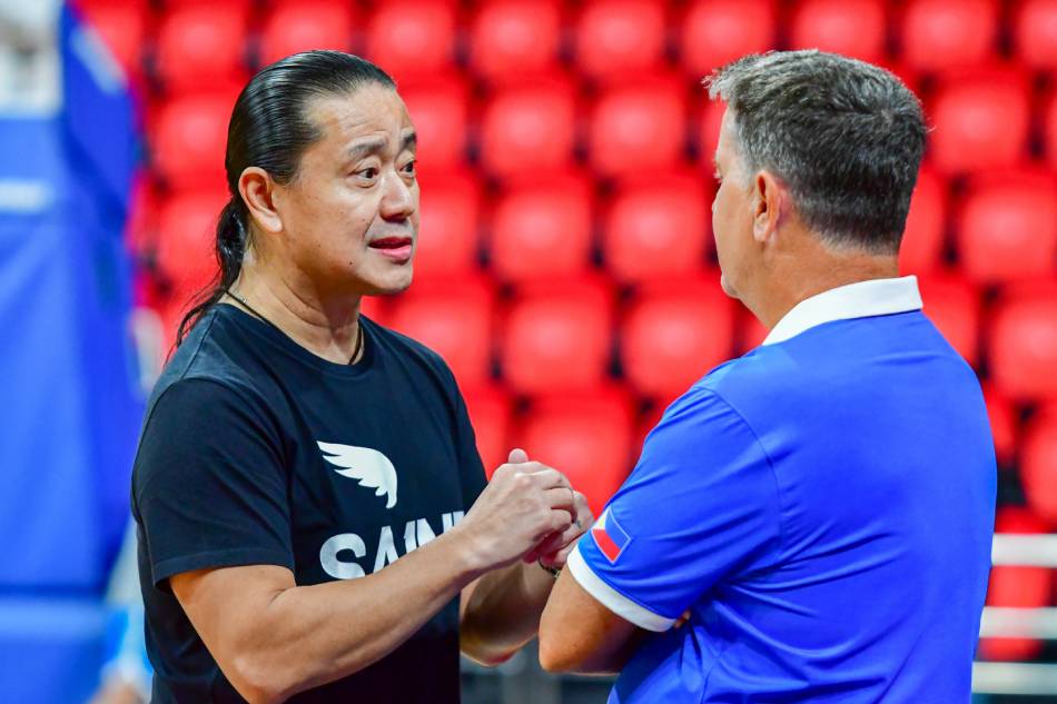 Gilas Pilipinas team official and San Miguel Corp. sports director Alfrancis Chua (L) talks with national team coach Tim Cone at the sidelines of a joint practice between the Gilas Men's and Women's teams in Pasig City on September 14, 2023, as part of their preparations for the upcoming Asian Games. Mark Demayo, ABS-CBN News