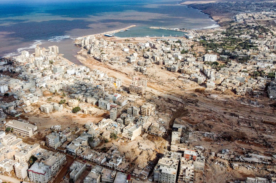 An aerial view shows Libya's eastern city of Derna on September 18, 2023, following deadly flash floods. The enormous flood, fueled by torrential rains on September 10, had broken through two upstream dams and sent a giant wave crashing down the previously dry river bed, or wadi, that bisects the city of about 100,000 people.