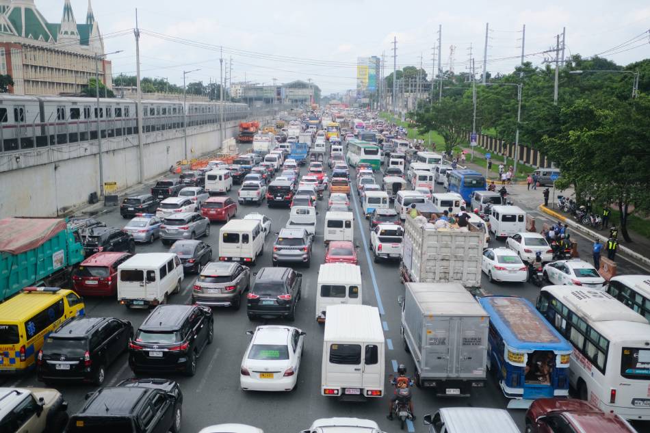Traffic builds up as anti-government protesters hold a program along Commonwealth Avenue in Quezon City hours before the 2nd State of the Nation of Address of President Ferdinand Marcos Jr. Alec Corpuz, ABS-CBN News