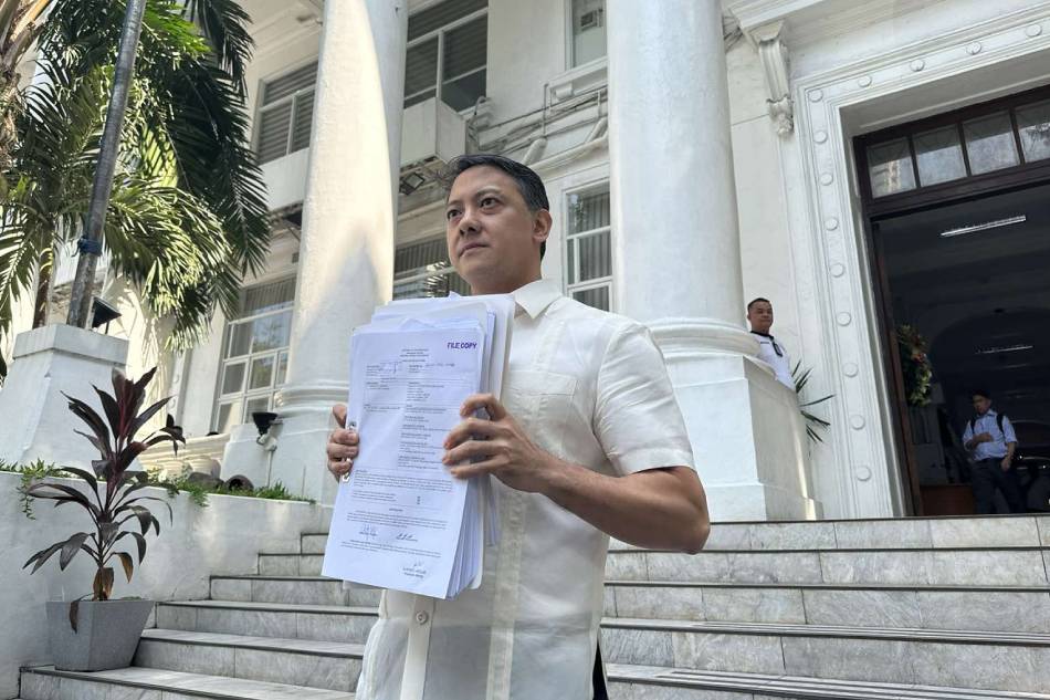 BIR Commissioner Romeo Lumagui stands in front of the Department of Justice building in Manila and holds a copy of one of the cases the agency is filing against firms allegedly in fake receipts on Nov. 22, 2023. Andrea Taguines, ABS-CBN News