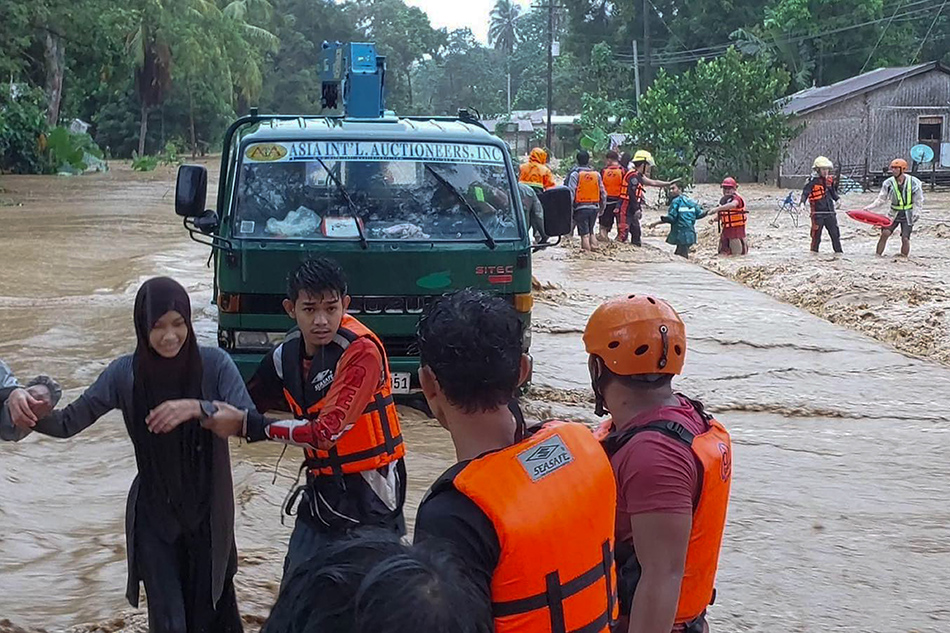 Residents wade through the flood in Brooke