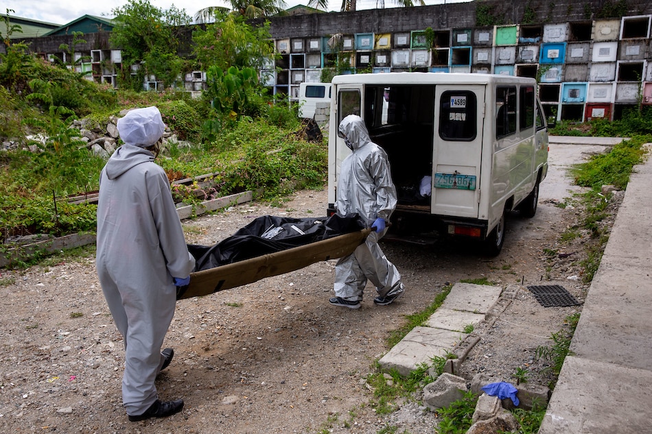 Workers process the body of fatalities during the enhanced community quarantine in Metro Manila at the Baesa Crematorium in Novaliches on May 5, 2020. Fernando G. Sepe Jr., ABS-CBN News/File