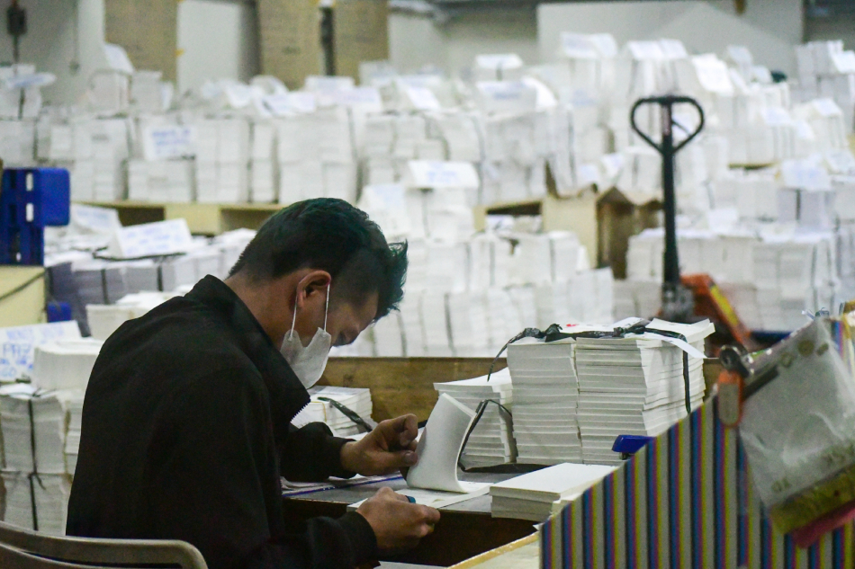 Workers check printed ballots for the 2023 Barangay and Sangguniang Kabataan (SK) elections for errors and flaws, which are being prepared for packaging and release at the National Printing Office on January 11, 2023. Mark Demayo, ABS-CBN News/file