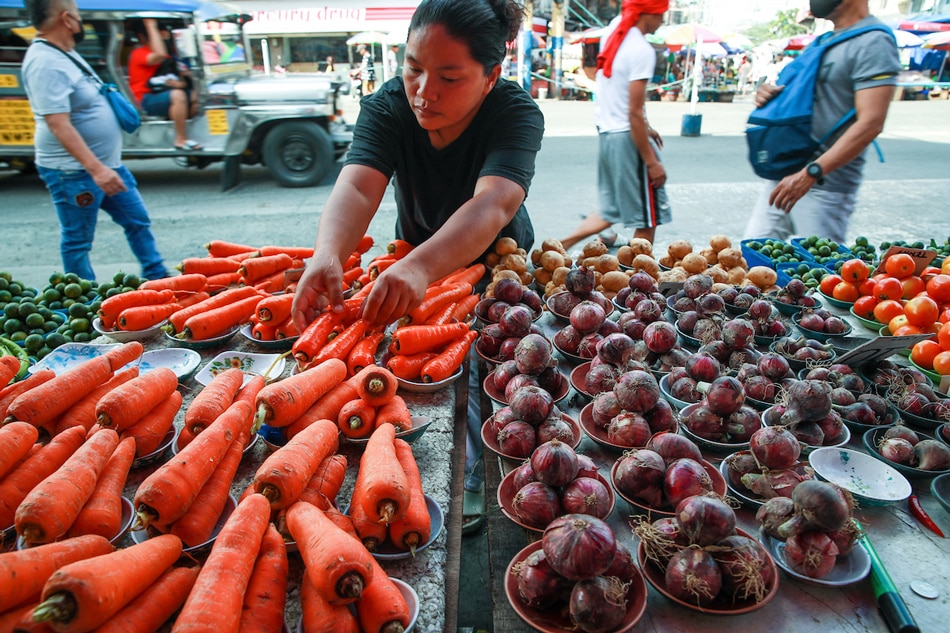 A vendor sells onions as well as other vegetables in smaller portion at a stall in Blumentritt Market in Manila on January 23, 2023. Jonathan Cellona, ABS-CBN News