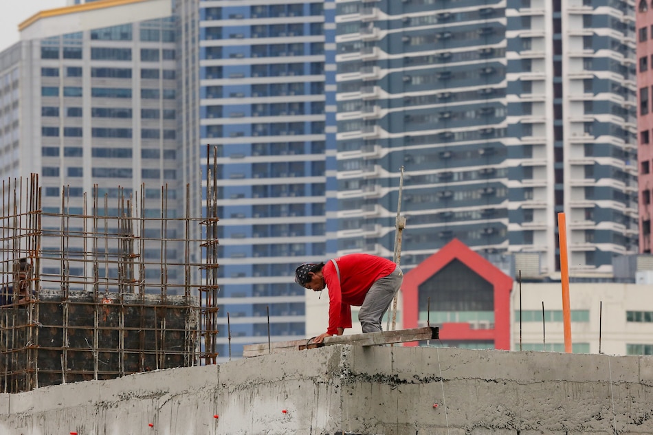 Construction workers on top of an unfinished building in Makati on August 24, 2022. George Calvelo, ABS-CBN News