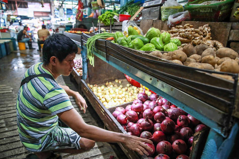  A produce vendor attends to the store’s inventory of both local and imported onions at a public market in Marikina City on January 25, 2023. Jonathan Cellona, ABS-CBN News