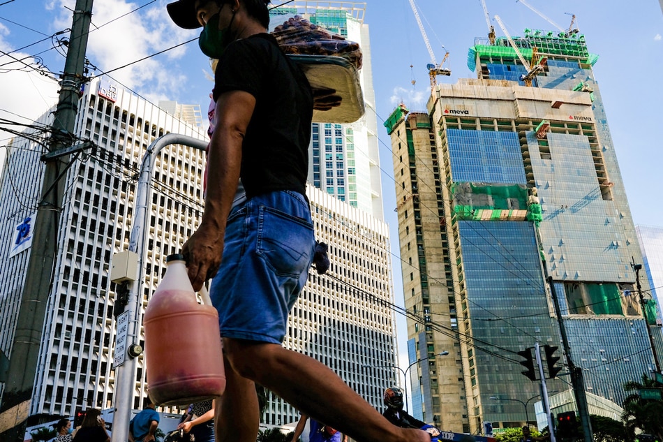  Pedestrians cross an intersection in the Makati Business District on October 6, 2022. The Philippine Statistics Authority said around 2.68 million Filipinos were jobless in August as the unemployment rate climbed to 5.3 percent from 5.2 percent in July. George Calvelo, ABS-CBN News