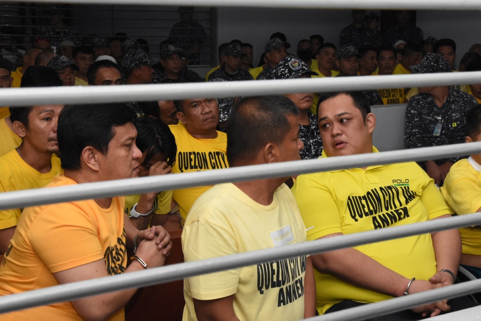 This handout photo from the Supreme Court - Public Information Office (SC-PIO) taken and released on Dec. 19, 2019 shows Andal Ampatuan Jr (front L) and others accused of involvement in the 2009 Maguindanao massacre waiting to hear the court's verdict at the trial venue inside a prison facility in Manila. Handout, Supreme Court Public Information Office via AFP/File