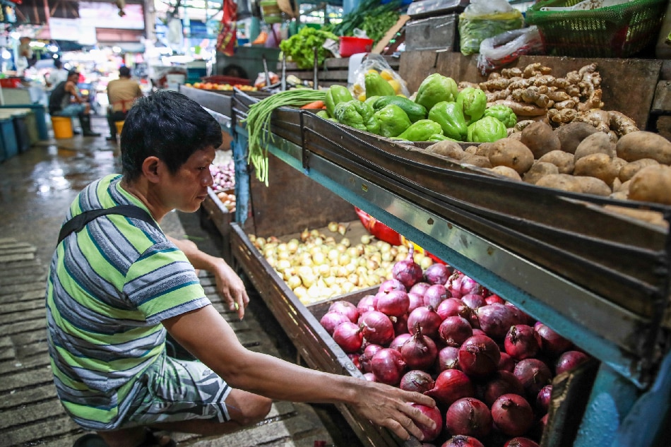 A produce vendor attends to the store’s inventory of both local and imported onions at a public market in Marikina City on January 25, 2023. Jonathan Cellona, ABS-CBN News