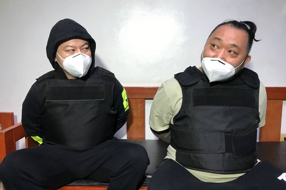 Japanese fugitives Yuki Watanabe and Tomonobu Saito, in custody of Philippine authorities, shortly before they were deported on Wednesday night. Bureau of Immigration