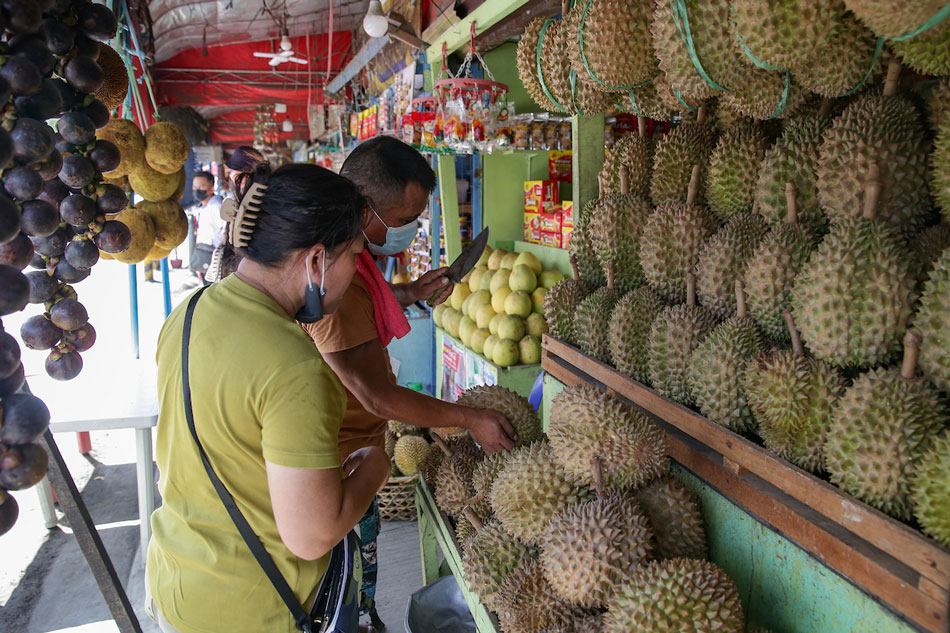 Durian and pomelo vendors man their stalls at a market in Davao City on June 18, 2022. George Calvelo, ABS-CBN News