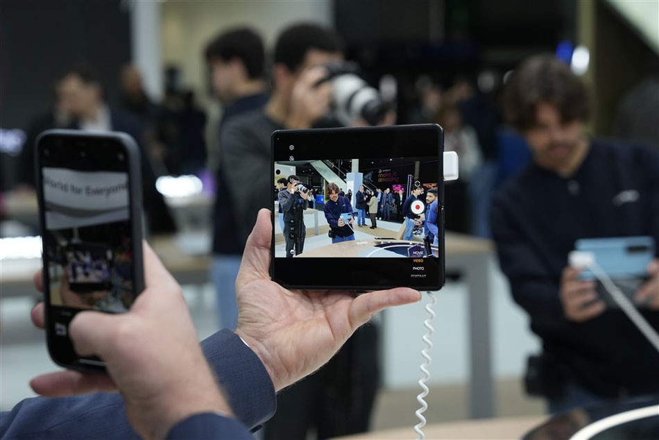 A visitor films a smartphone at Fira Barcelona in Barcelona, Spain, Feb. 27, 2023. Alejandro Garcia, EPA-EFE
