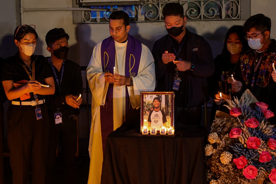 Faculty and students of Adamson University in Manila light candles outside the campus on March 1, 2023 to honor suspected hazing victim John Matthew Salilig Salilig’s body was found in a vacant lot in Cavite after more than a week of being reported missing when a person of interest in the chemical engineering student’s death disclosed the location to authorities. Jire Carreon, ABS-CBN News