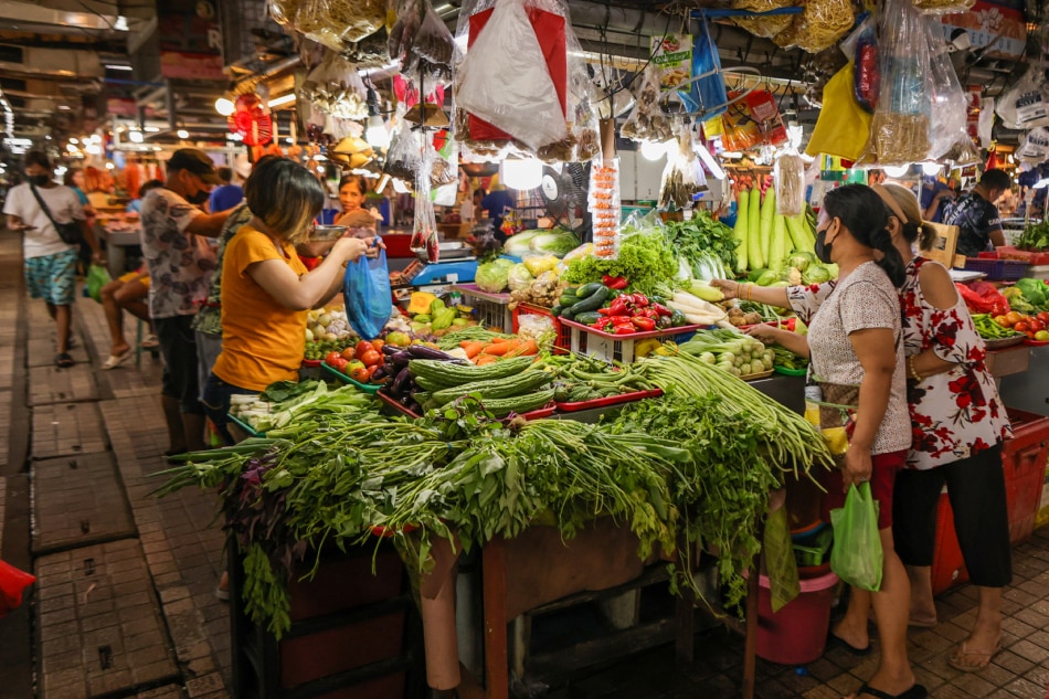 People buy produce at the Agora Public Market in San Juan City on Feb. 21, 2023. Maria Tan, ABS-CBN News