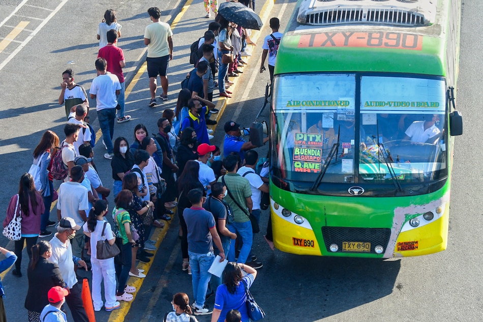 Commuters try to catch a ride along Commonwealth Avenue in Quezon City on March 6, 2023 amid a week-long transport strike by a number of jeepney operators and drivers. Free rides were deployed by local government units and other government agencies to aid commuters amid the strike. Mark Demayo, ABS-CBN News/File