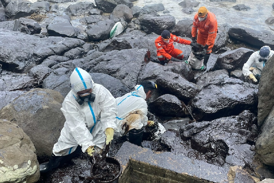 Volunteers and residents help clean up the shore affected by an oil spill in Barangay Tagumpay, Pola, Oriental Mindoro on March 2,2023. Dennis Datu, ABS-CBN News