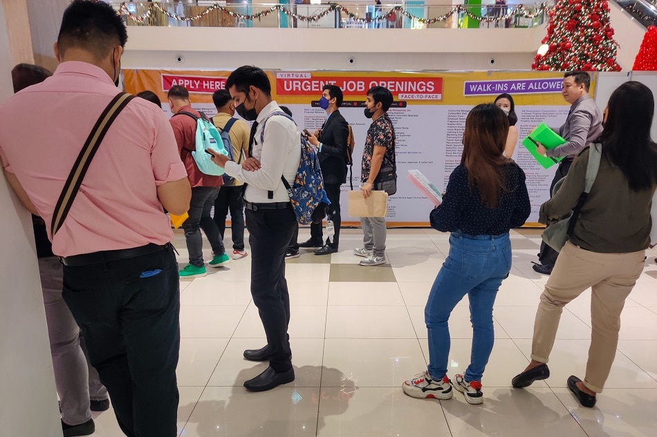 Job-seekers queue at a job fair in Quezon City on November 8, 2022. Mark Demayo, ABS-CBN News/File.