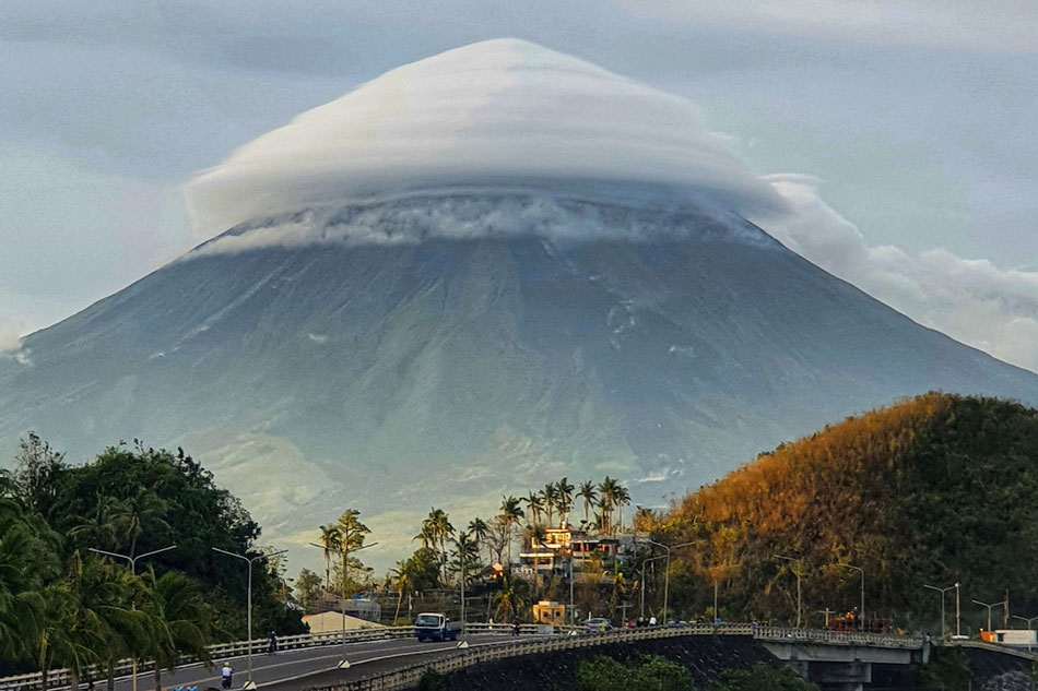 Mayon Volcano is pictured covered by an umbrella-like cloud from Puro, Legazpi City in Albay. Chito L. Aguilar, ABS-CBN News/File