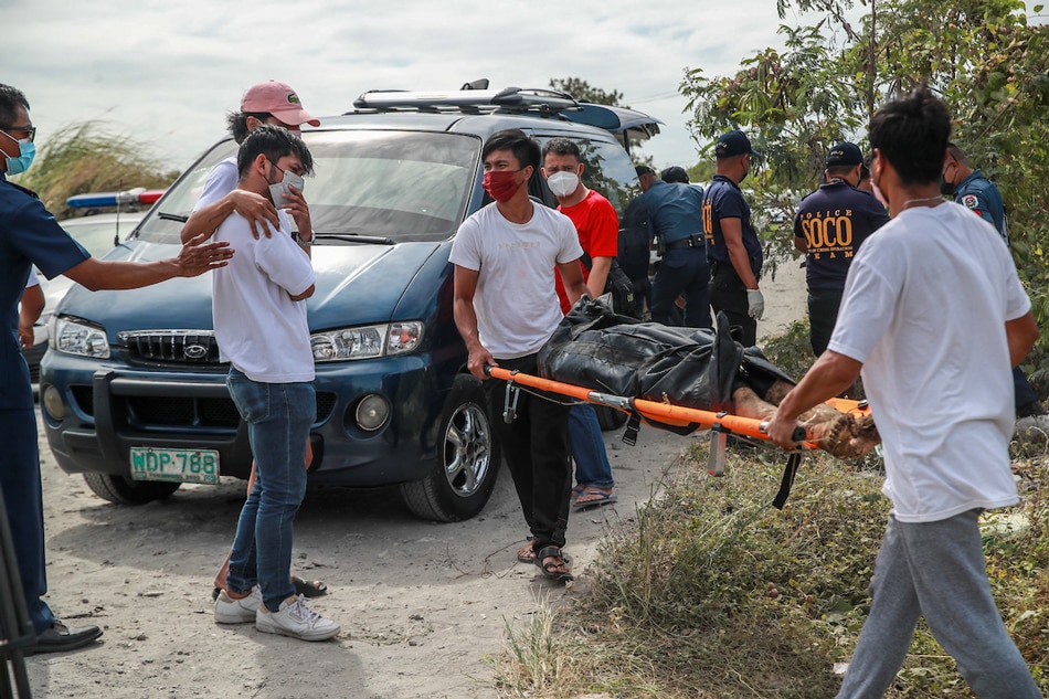 Members of the Philippine National Police Scene of the Crime Operatives process a crime scene to identify a body pulled from a shallow grave by the Public Information Unit of Cavite Police Provincial Office (PIU Cavite PPO) and Imus City Police Station (Imus CPS) inside the Jade Residences Subdivision in Barangay Malagasang, Imus City on February 28, 2023. John Martin Salilig positively identified the remains of his missing brother 24-year-old Adamson University Chemical Engineering student John Matthew Salilig. Jonathan Cellona, ABS-CBN News/File