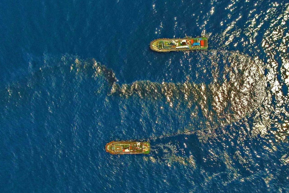 The Philippine Coast Guard deploys an oil spill boom and skimmer with manual scooping around the suspected area of the sunken MT Princess Empress northeast of Balingawan Port, Lucta Port, and Buloc Bay in Oriental Mindoro on March 14, 2023. Photo courtesy of Malayan Towage and Salvage Corporation/Philippine Coast Guard