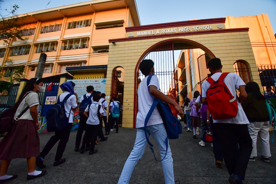 Security officers from the Quezon City Department of Public Order and Safety check the bags of students using metal detectors at Manuel A. Roxas High School in Quezon City on Feb. 1, 2023. The increased security measure in the school is implemented in response to the recent cases of violence in campuses. Mark Demayo, ABS-CBN News/File