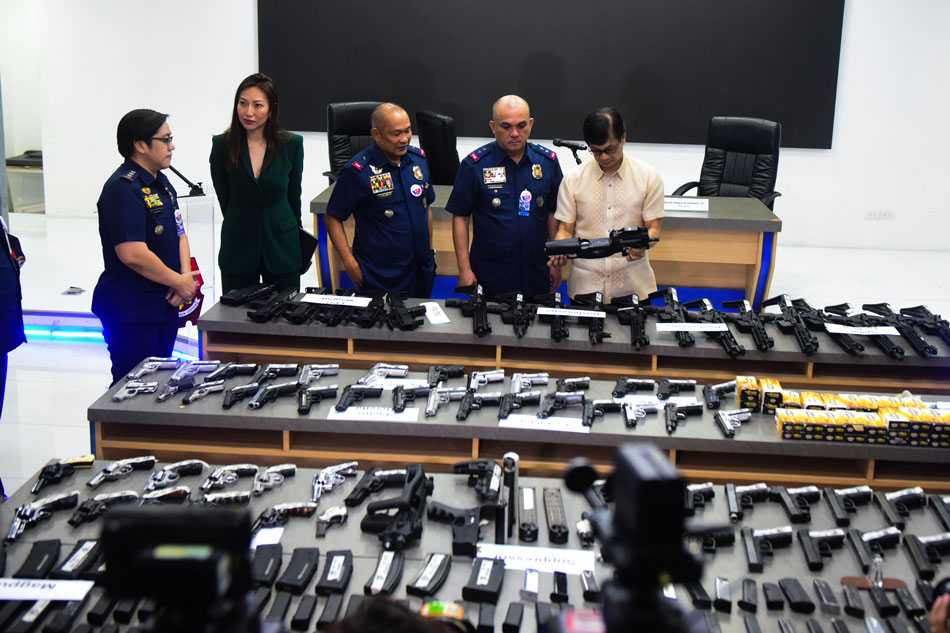 A cache of firearms allegedly owned by Taiwanese nationals is presented to the media at the Philippine National Police Media Center in Camp Crame in Quezon City on March 21, 2023. The firearms which include pistols, machine guns, rifles, and ammunition were seized inside a condominium unit in Makati City on March 20 by units of the Philippine National Police Criminal Investigation and Detection Group (PNP-CIDG) Anti Organized Crime Unit, Philippine Drug Enforcement Agency (PDEA), and Makati City Police. Maria Tan, ABS-CBN News