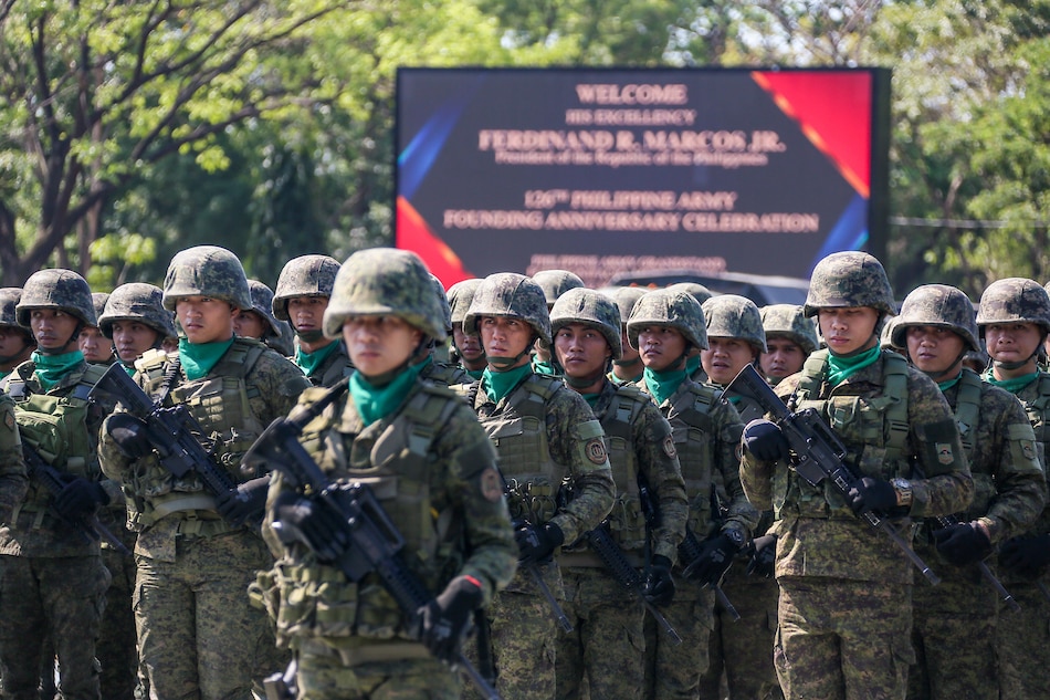 Philippine Army soldiers stand at attention during the celebration of the 126th Philippine Army Founding Anniversary in Fort Bonifacio, Taguig City on March 22, 2023. Jonathan Cellona, ABS-CBN News