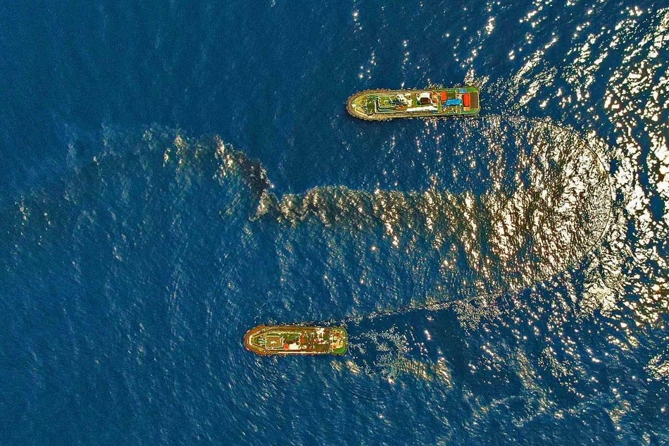 The Philippine Coast Guard deploy an oil spill boom and skimmer with manual scooping around the suspected area of the sunken MT Princess Empress approximately 7.1 nautical miles northeast of the shorelines of Balingawan Port, Lucta Port, and Buloc Bay in Oriental Mindoro on March 14, 2023. Photo courtesy of Malayan Towage and Salvage Corporation/Philippine Coast Guard