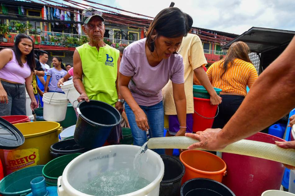 Residents of Barangay 165 in Pasay City stock up on delivered water from a mobile tanker on March 5, 2023. Mark Demayo, ABS-CBN News