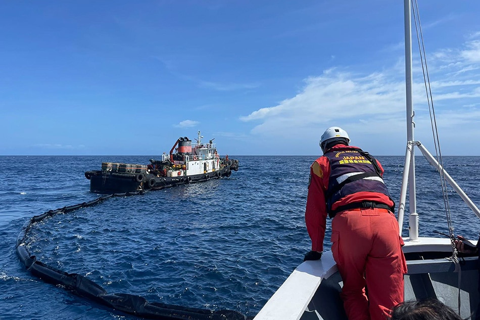 Members of the Japan Coast Guard Disaster Relief Team help in the containment of the oil spill from MT Princess Empress aboard the BRP Bagacay of the Philippine Coast Guard on March 17, 2023. Dennis Datu, ABS-CBN News