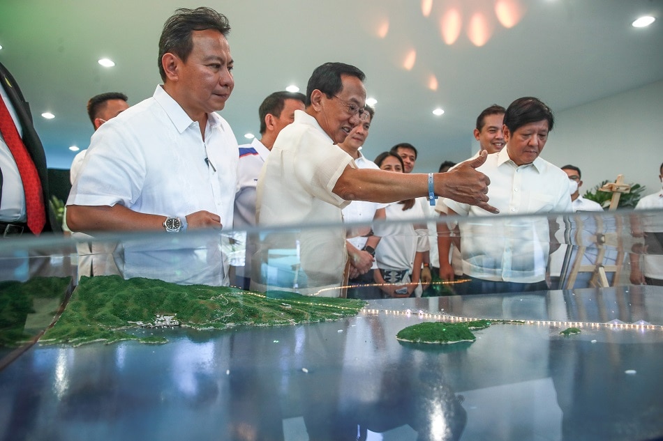 President Ferdinand R. Marcos Jr. looks at a scale model of the Bataan-Cavite Interlink Bridge Milestones (BBM) project during ceremonies at the Maritime Academy of Asia and the Pacific in Barangay Alas-Asin, Mariveles, Bataan on March 31, 2023. He is joined by DPWH Secretary Manuel M. Bonoan. Jonathan Cellona, ABS-CBN News/PPA pool