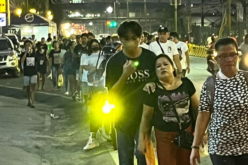 Devotees walk in procession towards Antipolo Cathedral during Maundy Thursday, April 6, 2023. Jose Carretero, ABS-CBN News