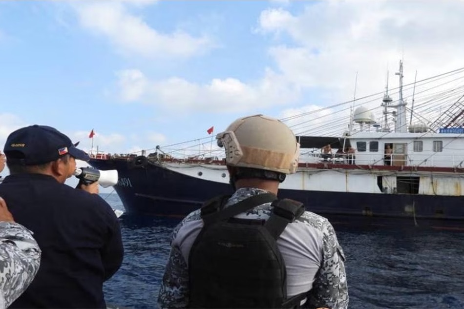 Philippine Coast Guard personnel attempt to disperse a large group of Chinese militia vessels in the West Philippine Sea. Photo from Philippine Coast Guard 
