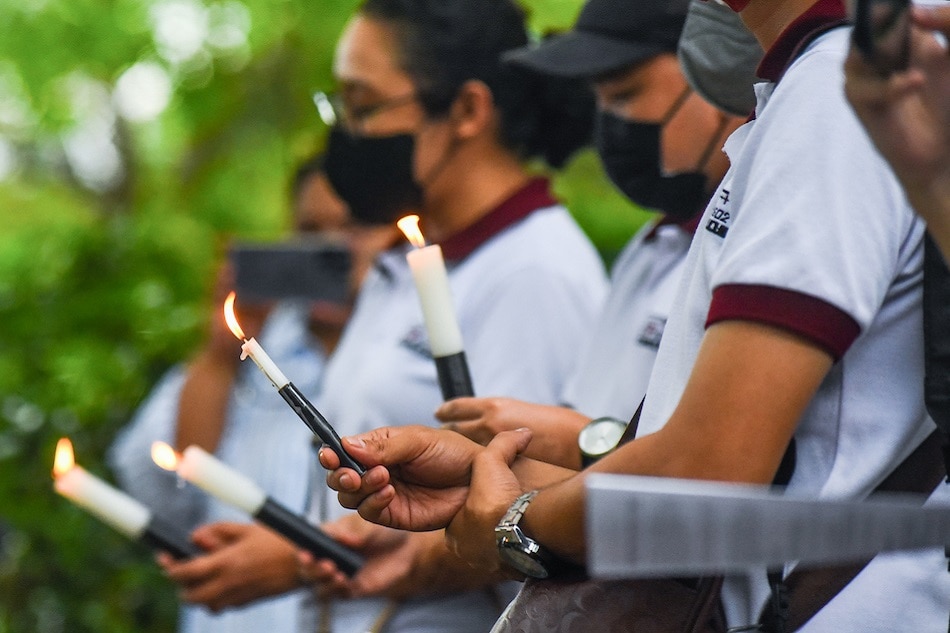 Media rights advocates light candles and sign a pledge to promote human rights as they observe World Freedom Day at University of the Philippines in Diliman, Quezon City on May 3, 2023. The group also lit candles at the Freedom Wall of the College of Mass Communication which serves as a memorial for media practitioners who perished in the course of their jobs. Maria Tan, ABS-CBN News
