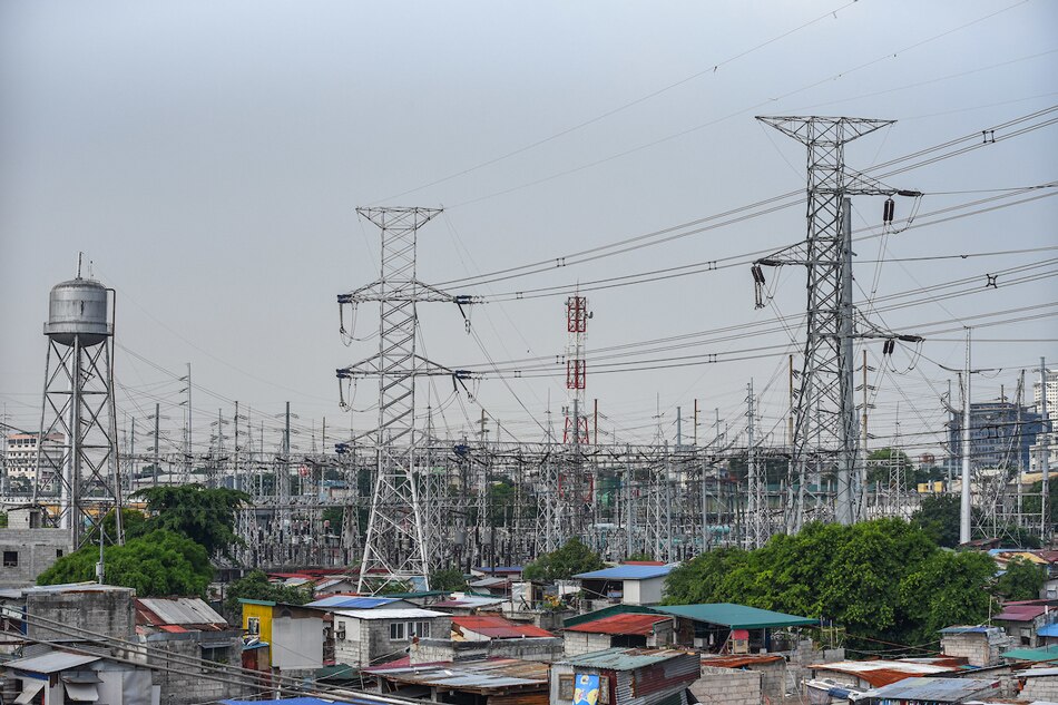 High voltage towers that support transmission lines for electrical power distribution in the Luzon grid is seen from a residential area in Baesa, Quezon City on Tuesday, May 9 2023. Maria Tan, ABS-CBN News